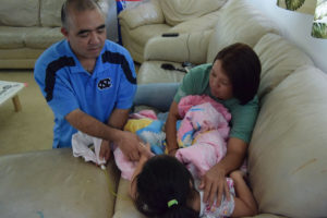 Jari Sugano and her husband Reid Kaneshiro administer a form of medical marijuana to their dauther, Malie-Jen, within their home in Oahu, Hawaii. (Photo by Anne M. Shearer/News21.)